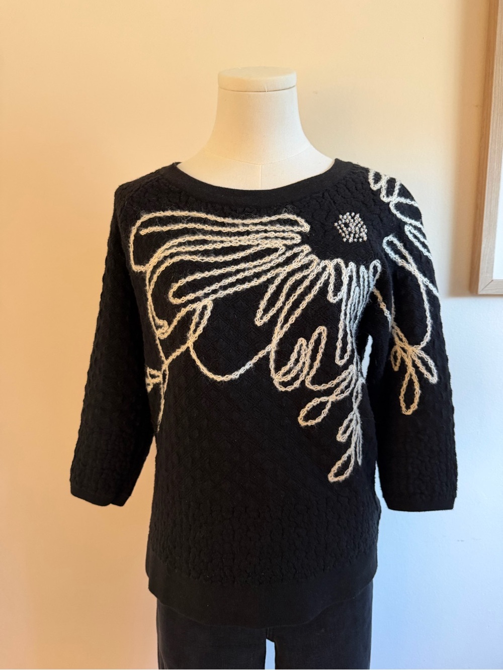 Anthropologie Black Crewneck Sweater with Cream Rope-Style Floral Motif